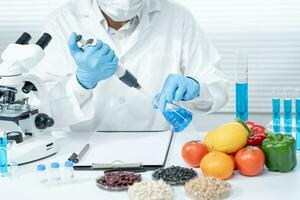 Scientist check chemical food residues in laboratory. Control experts inspect quality of vegetables  vegetables. lab, hazards, find prohibited substances, contaminate, Microscope, Microbiologist photo