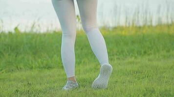 Young woman stretching before running while looking for beautiful landscape on roadside. Sports and Recreation video