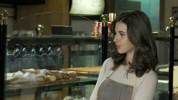 Charming female baker smiling to the camera at her bakery store video