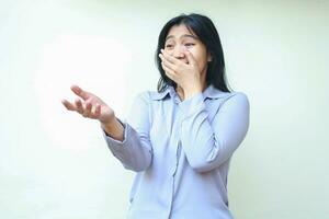 scared asian young business woman reaching hands with open palm looking away shocked covering her mouth wide open wearing formal shirt standing over isolaed white background photo