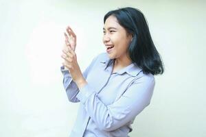 shocked happy asian young business woman looking aside raising hands with open palm try to covering her face wearing formal office shirts standing over isolated white background photo