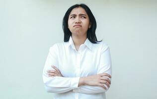 image of sad asian business woman folded arms crossed hand look aside worries showing fear and afraid expression, standing regret her mistakes with gloomy face photo