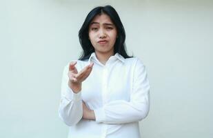 studio shot of annoyed asian business woman manager thinking about something with hand reaching towards camera and arms folded, female executive asking and questioning photo