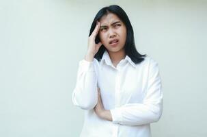 image of confused asian young business woman grabbing her head and folded arms stressed, do not believe of bankruptcy expression, look away pondering standing daydream photo