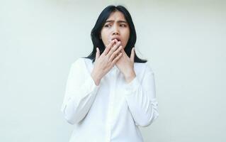 portrait of displeased shock asian business woman covering face with hands looking away showing disbeliefe face expression wearing white shirt formal suit standing isolated background photo