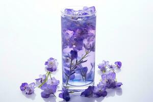 Color changing butterfly pea flower tea in a glass isolated on a white background photo