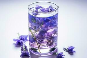 Color changing butterfly pea flower tea in a glass isolated on a white background photo