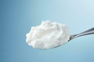 Whipped air infused foam displayed on spoon isolated on a gradient background photo