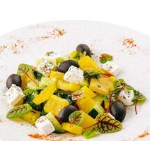 Greek salad with feta cheese, olives and vegetables photo