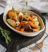 Gourmet chicken and pork stew bourguignon with carrots photo