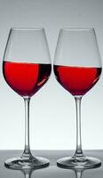 two glasses of wine on gray background photo