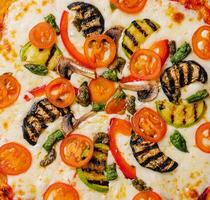 vegetarian pizza with zucchini, eggplant, mushrooms and tomato photo