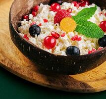 coconut bowl with cottage cheese and ripe berries photo