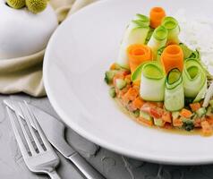 vegetable tartar of cucumber, carrot and tomato photo