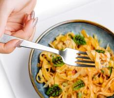 Italian spaghetti on fork close up photo