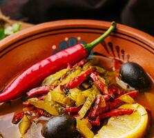 Meat Solyanka soup on a wooden board photo