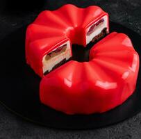 Contemporary Chocolate Cherry Mousse Cake covered with cherry icing photo