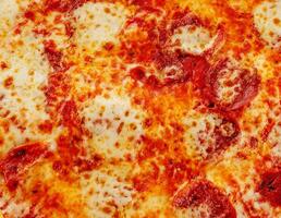 pizza with salami, parmesan cheese background photo