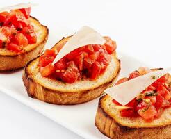 Traditional italian antipasto bruschetta appetizer with cherry tomatoes photo