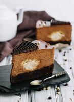 A piece of chocolate cake with tea photo