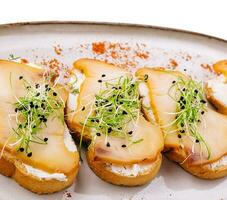 Delicious smoked halibut slices on toast bread photo