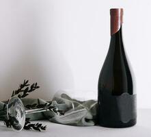 Glass and bottle of red wine photo