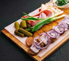 Rustic appetizer for vodka on wooden board photo