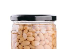 Jar of pickled beans isolated on white photo