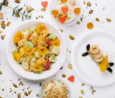 plate of fresh fruit salad and ice cream with jelly and nuts photo