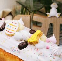 Easter cake with meringue decorated with chocolate bunny and eggs photo