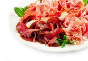 Assorted deli meats - ham, sausage, salami, parma, prosciutto photo