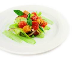 warm salad of stewed cherry tomatoes, cucumbers and croutons photo