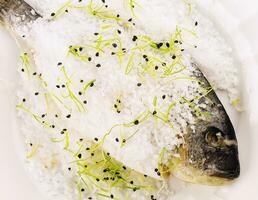 Fish baked in salt on plate photo