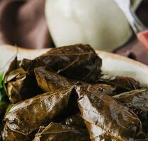 Dolma cabbage rolls grape leaves with filling closeup photo