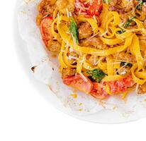 Tagliatelle pasta with grilled chicken fillet and tomatoes photo