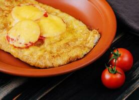 Chicken fillet baked in the oven with cheese and tomatoes photo