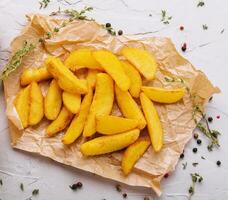 Baked fried potatoes with red and white sauces photo