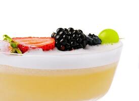 Close up Yellow Cocktail with white foam with berries photo