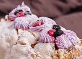 Meringue roll cake with cream and berries photo