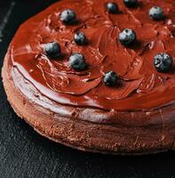 Delicious chocolate cake decorated with fresh blueberries photo