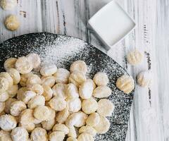 sweet, round cookies rolled in powdered sugar photo