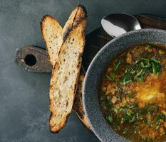 Onion soup with roasted bread top view photo