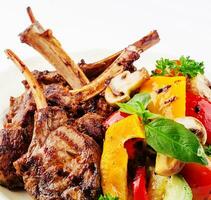 Grilled lamb rack with baked vegetables photo