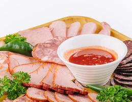 Assorted deli cold meats on wooden tray photo