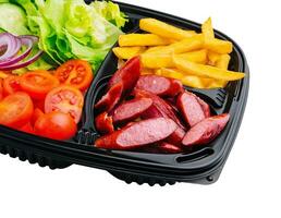 Grilled sausages, French fries and vegetables photo