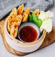 Vietnamese fresh summer rolls filled with prawns, herbs, rice vermicelli and vegetables photo