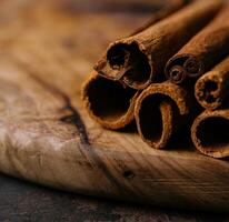 Cinnamon sticks on wooden background close-up photo