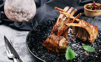 Beautifully grilled lamb rib chop steaks on plate photo