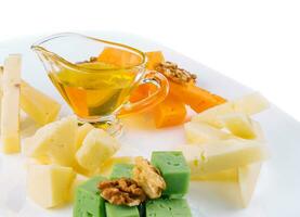 Cheese Platter with Honey, Nuts on white plate photo