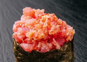 Gunkan sushi with tuna and tobiko on black photo